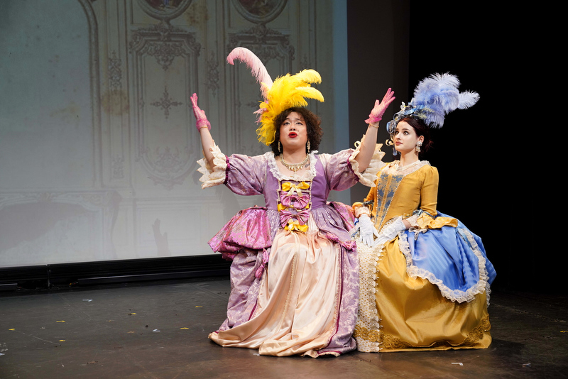 Two AMDA New York students in elaborate period costumes perform onstage in an acting showcase